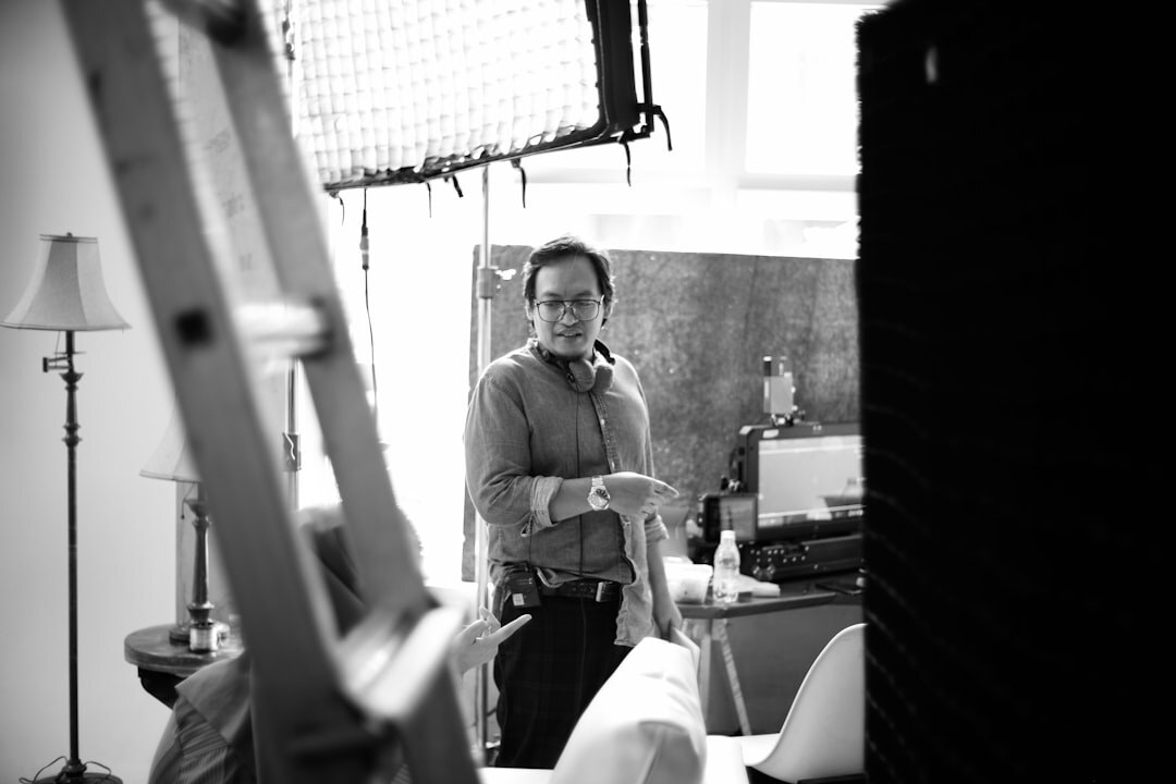 Studio lighting rig with softboxes and a technician adjusting the setup